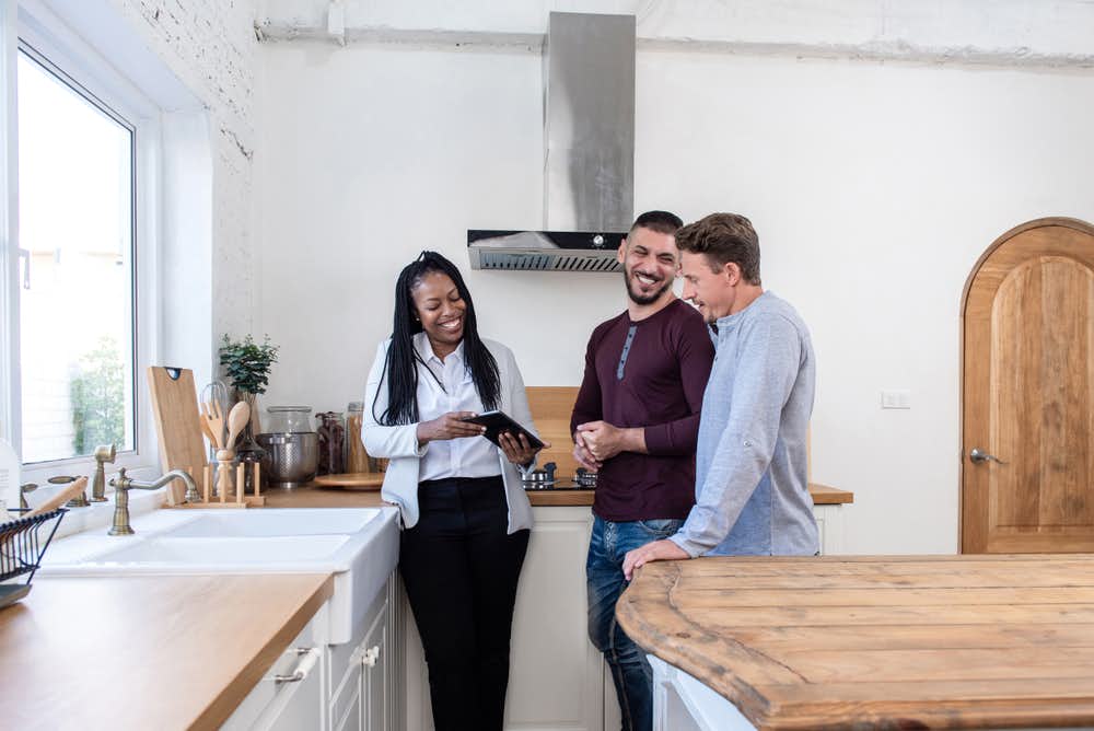 Woman showing young couple around a shared ownership property