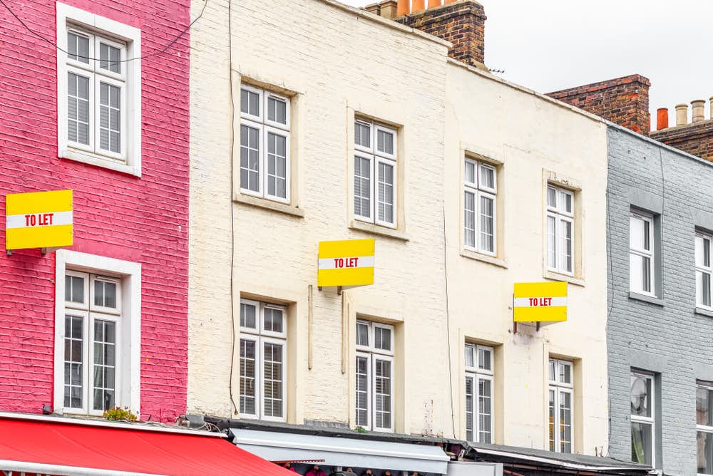 How to become a buy to let landlord. Image of colourful houses with To Let boards. 