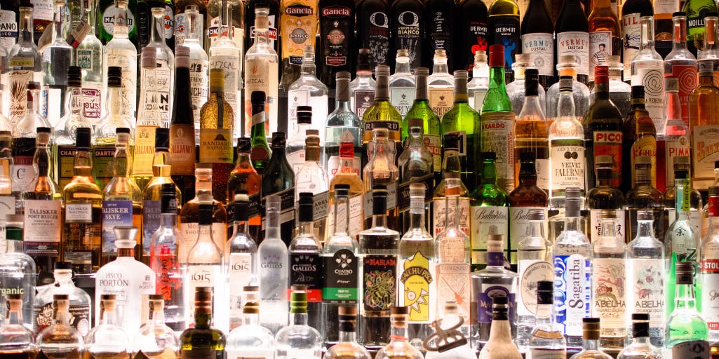 Image containing shelves of alcohol in a bar