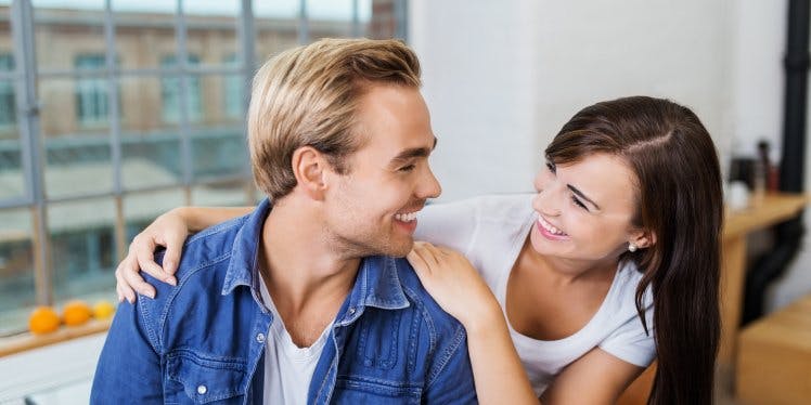 Young couple smiling at each other.