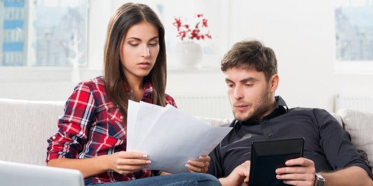 concerned-couple-looking-at-bills