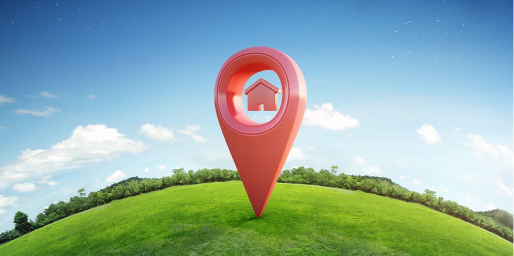 House symbol with location pin icon on earth and green grass in real estate sale.