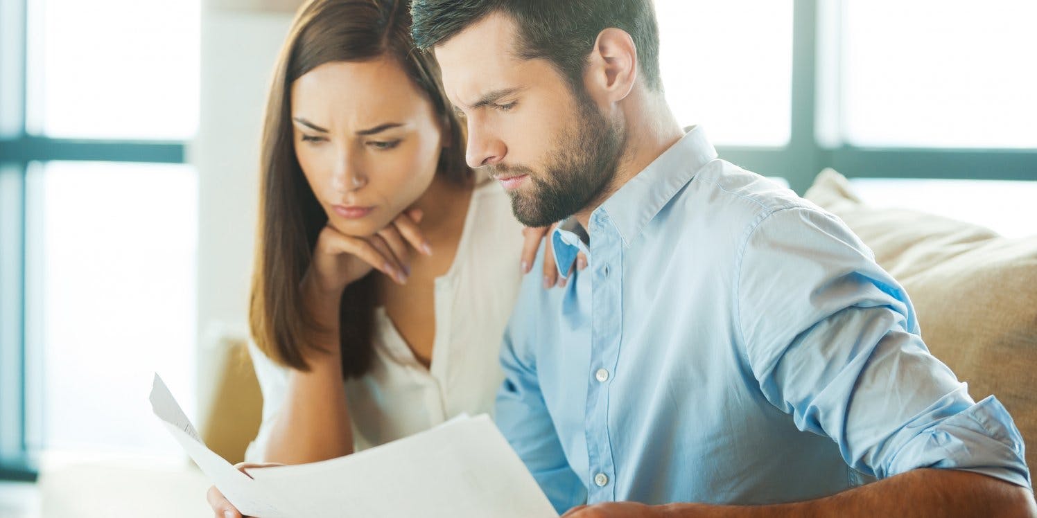 Concerned couple looking at bills
