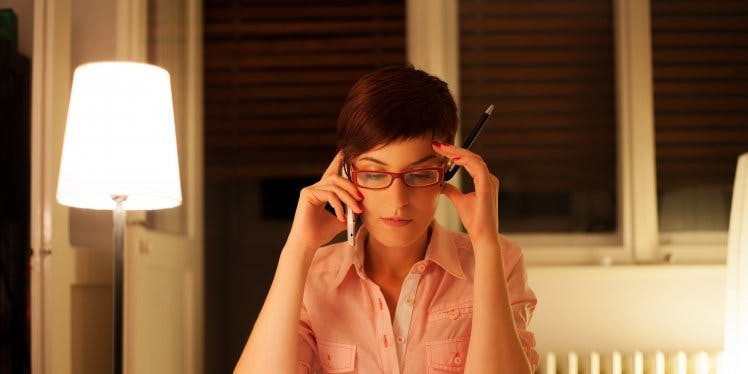 young-woman-on-phone-at-her-desk