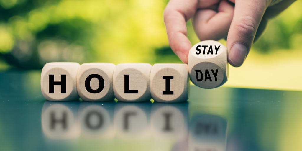 image of cubes spelling out "holi" in separate cubes, followed by the word "stay" on another cube to represent a staycation