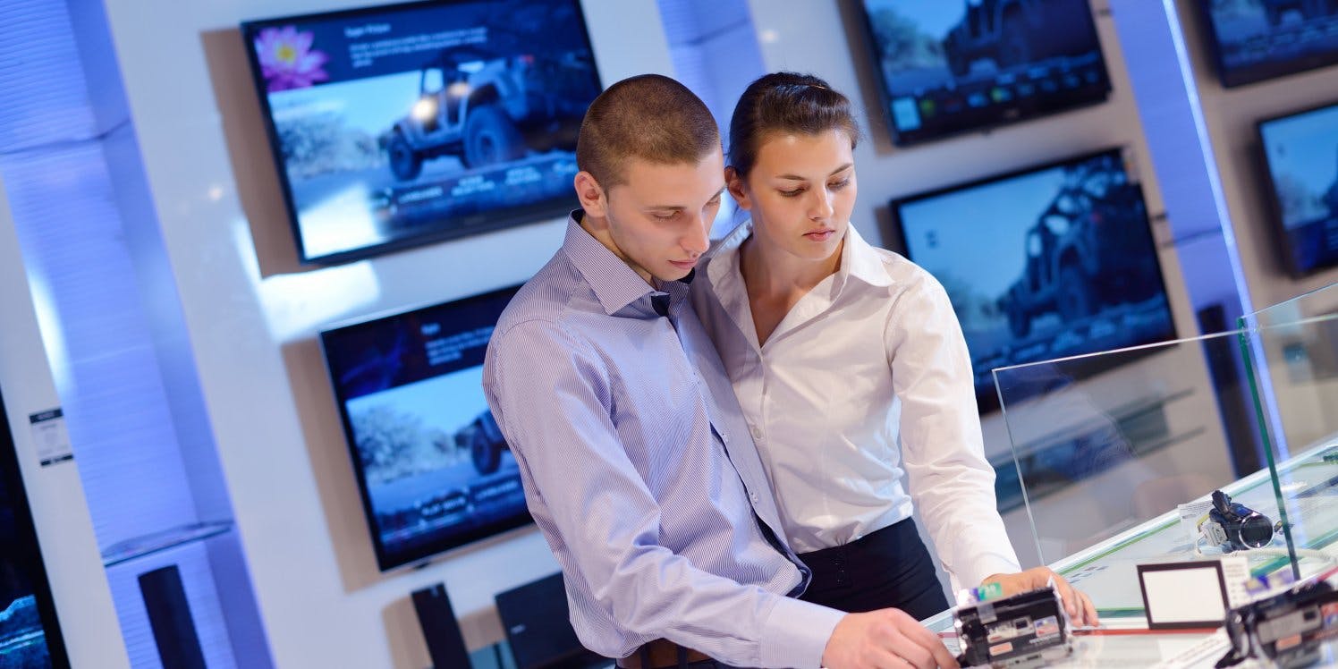 Couple browsing in electronics store 