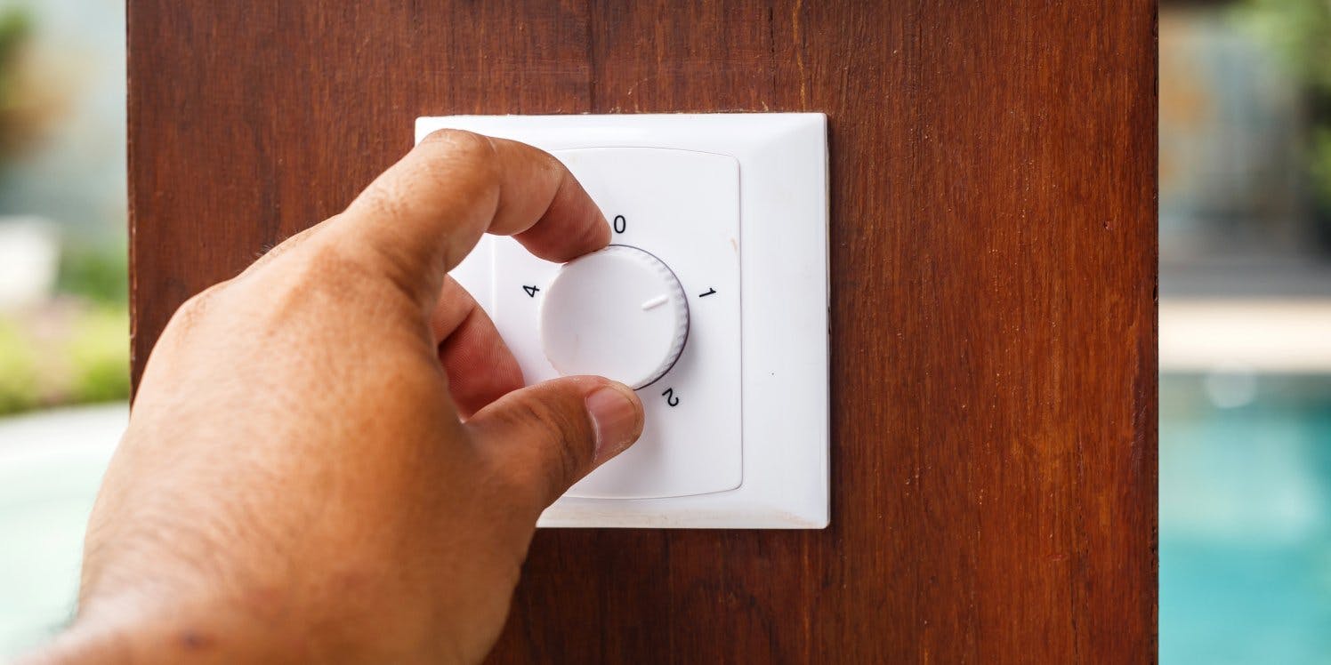 Person using thermostat