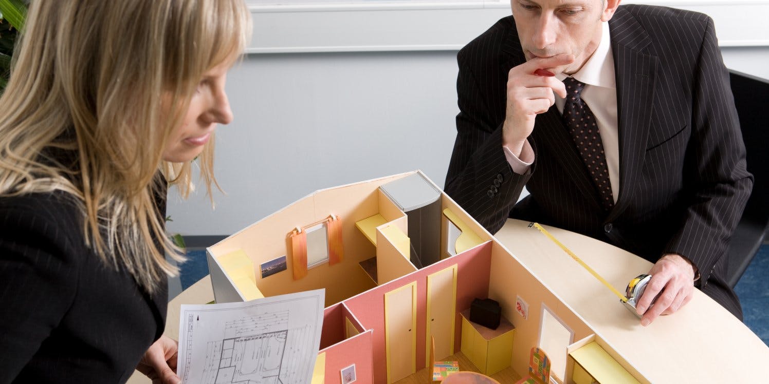 two people looking at property plans