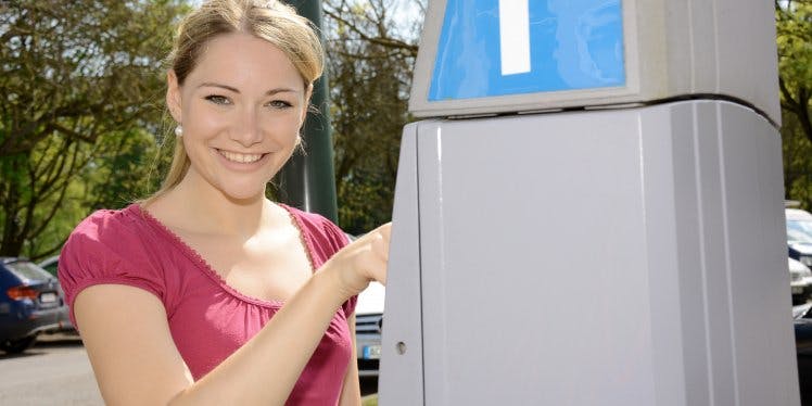 woman-buying-parking-ticket
