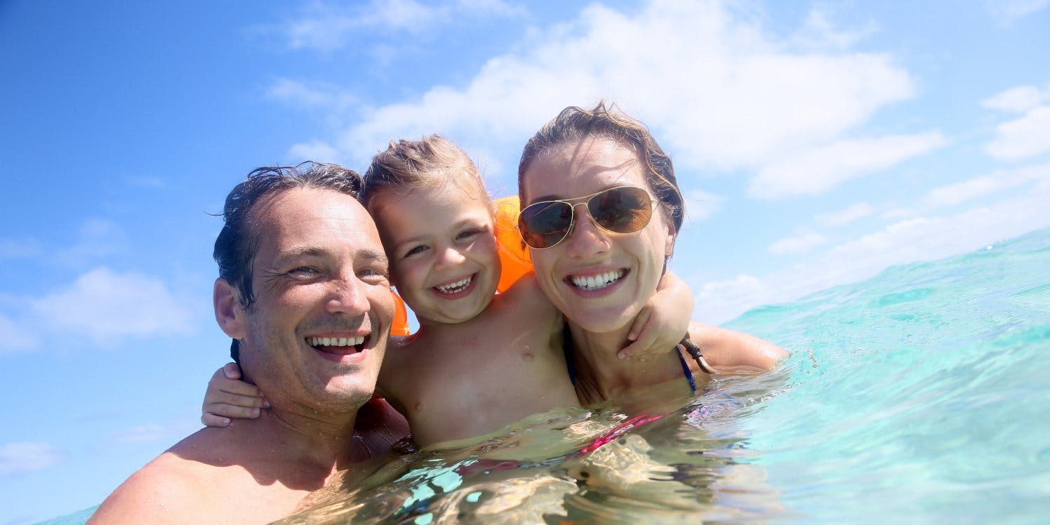 Smiling family in ocean