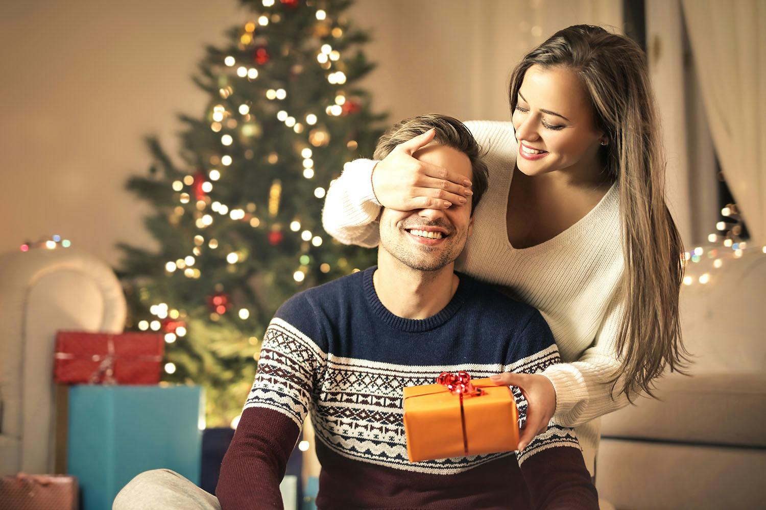 Girl giving christmas gift to boyfriend
