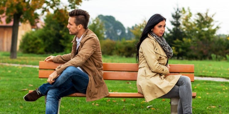 couple-split-apart-of-bench-outside